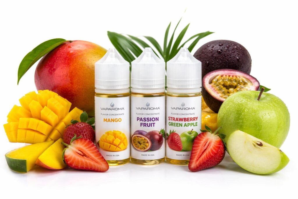 Fresh tropical fruits alongside professional e-liquid flavor concentrates, illustrating the sensory and perceptual associations between natural fruit imagery and consumer health halo effects in vaping product evaluation.